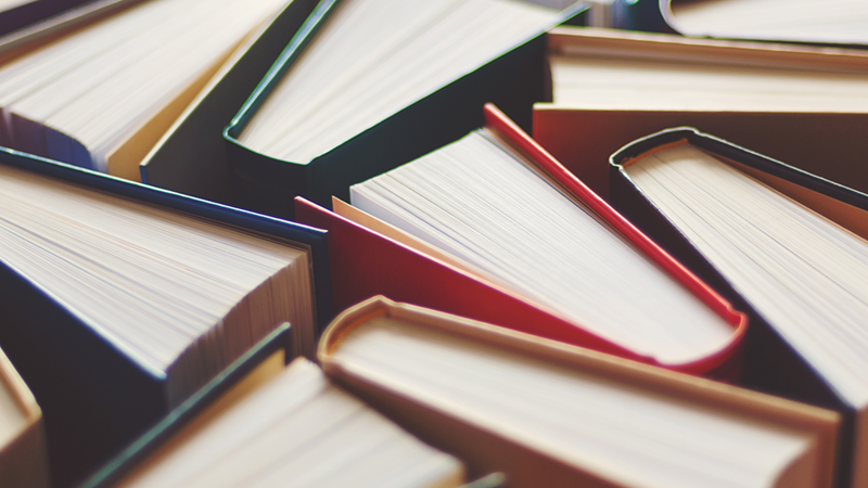 Improving your performance and delivery A photo of some books from the top