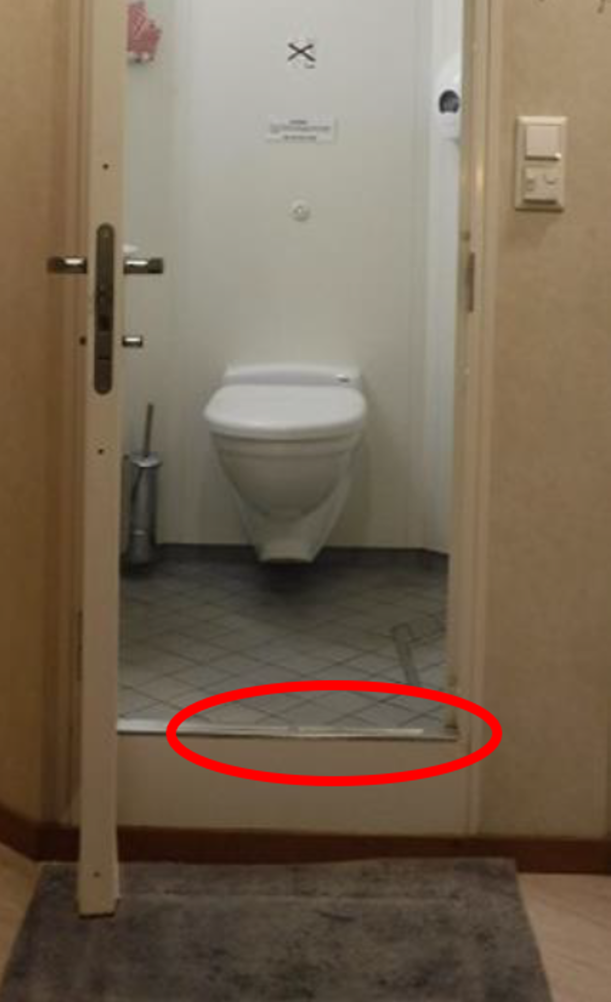crew member stepped out of the bathroom onto the cabin mat