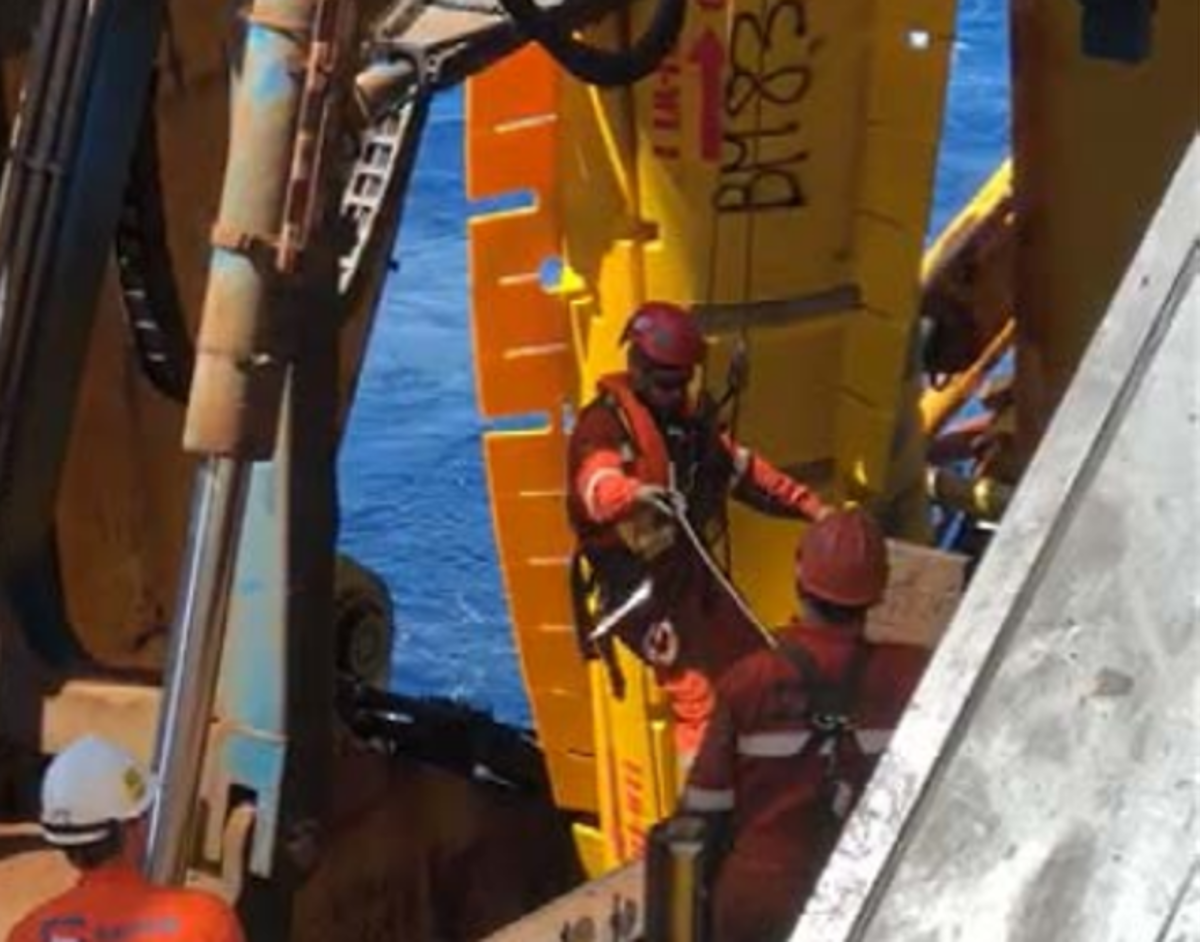 A rope access technician sustained an injury to the right shoulder while  accessing the vessel transom port-side platform, following buoyancy module  pad retrieval from the pipe string. Upon reaching the buoy loader area, the  rope access technician climbed on top of the platform handrail, lost grip when  reaching for the handrail, and fell approximately 1 m