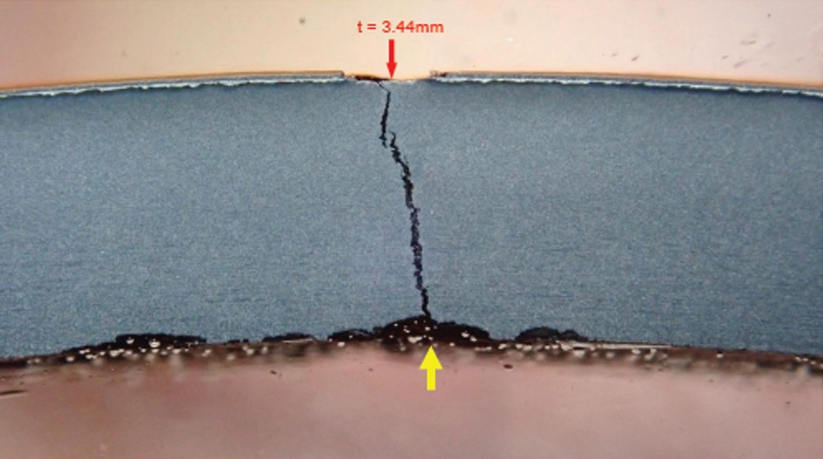 A cross-section through the cylinder wall at the leak location showing a through-thickness crack. The cylinder suffered internal corrosion at the crack location, with a measured remaining wall thickness of 3.44 mm.