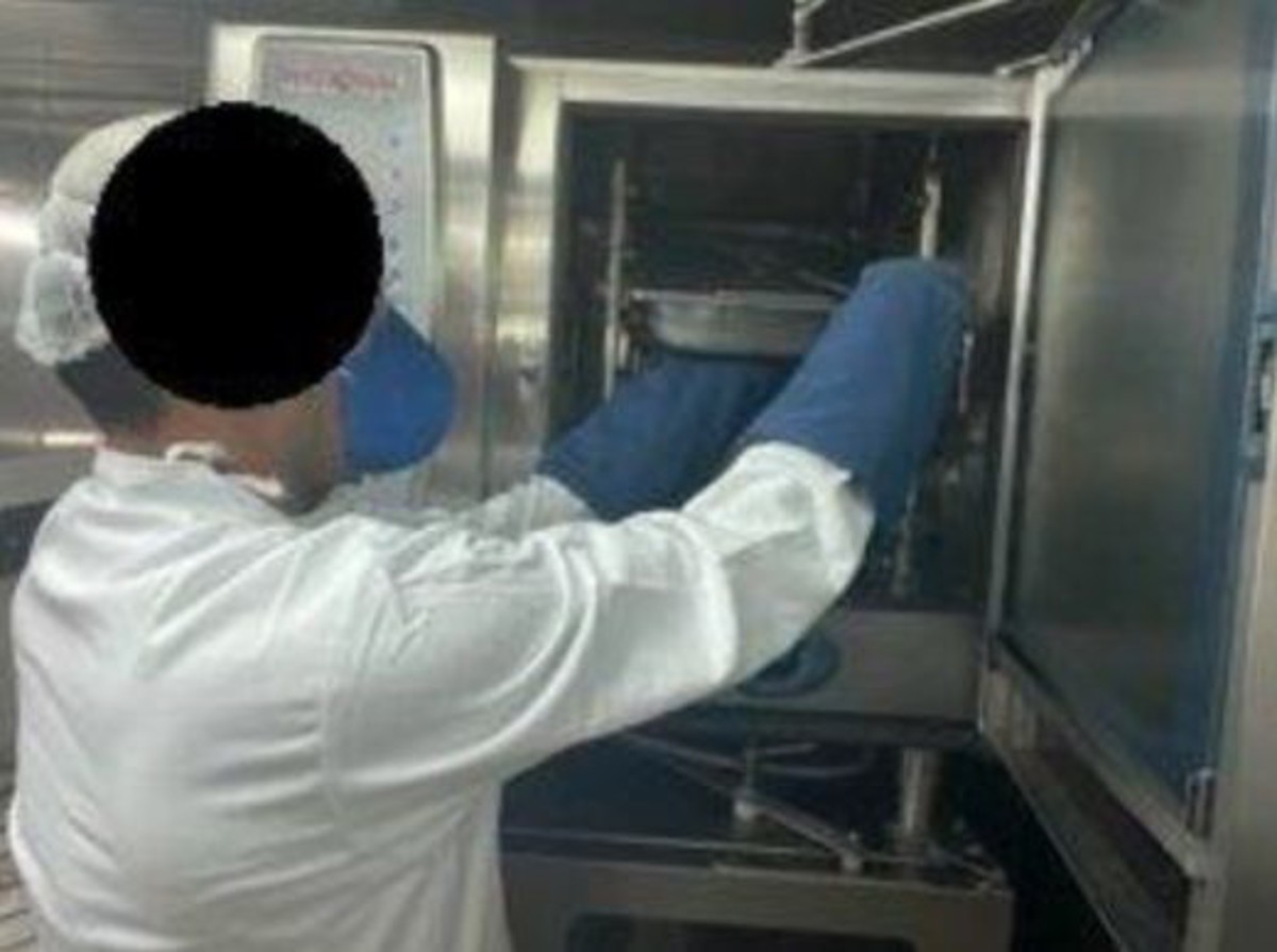 Photo of cook pulling out tray