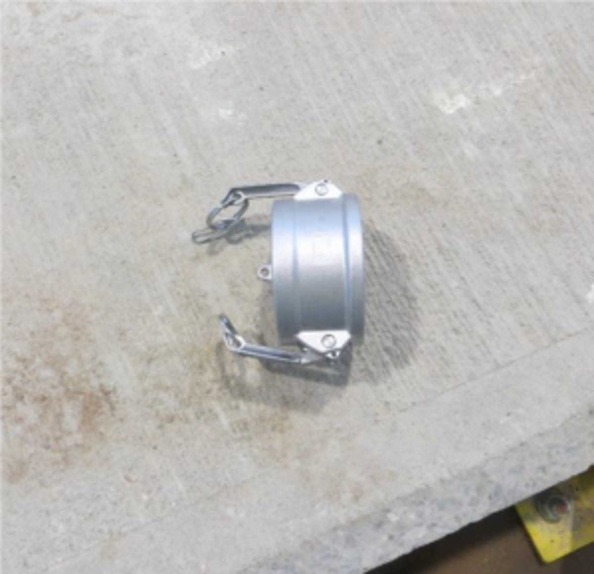 A fire main dust cap was blown off by pressure from the line and hit the wall 10m away.  