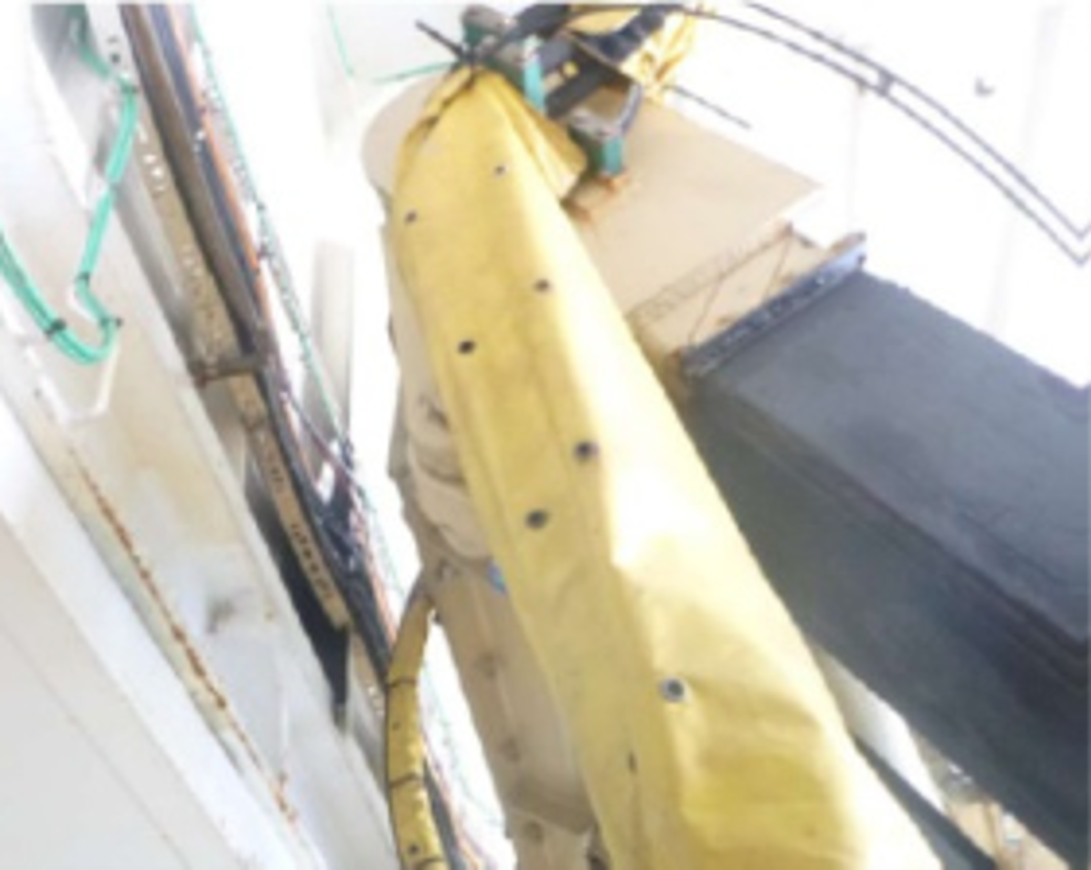 Cables and hoses in  the ROV hanger had been inadvertently severed by the ROV  launch and recovery (LARS) frame which had come into contact  with the bulkhead cable tray (yellow structure in second photo).