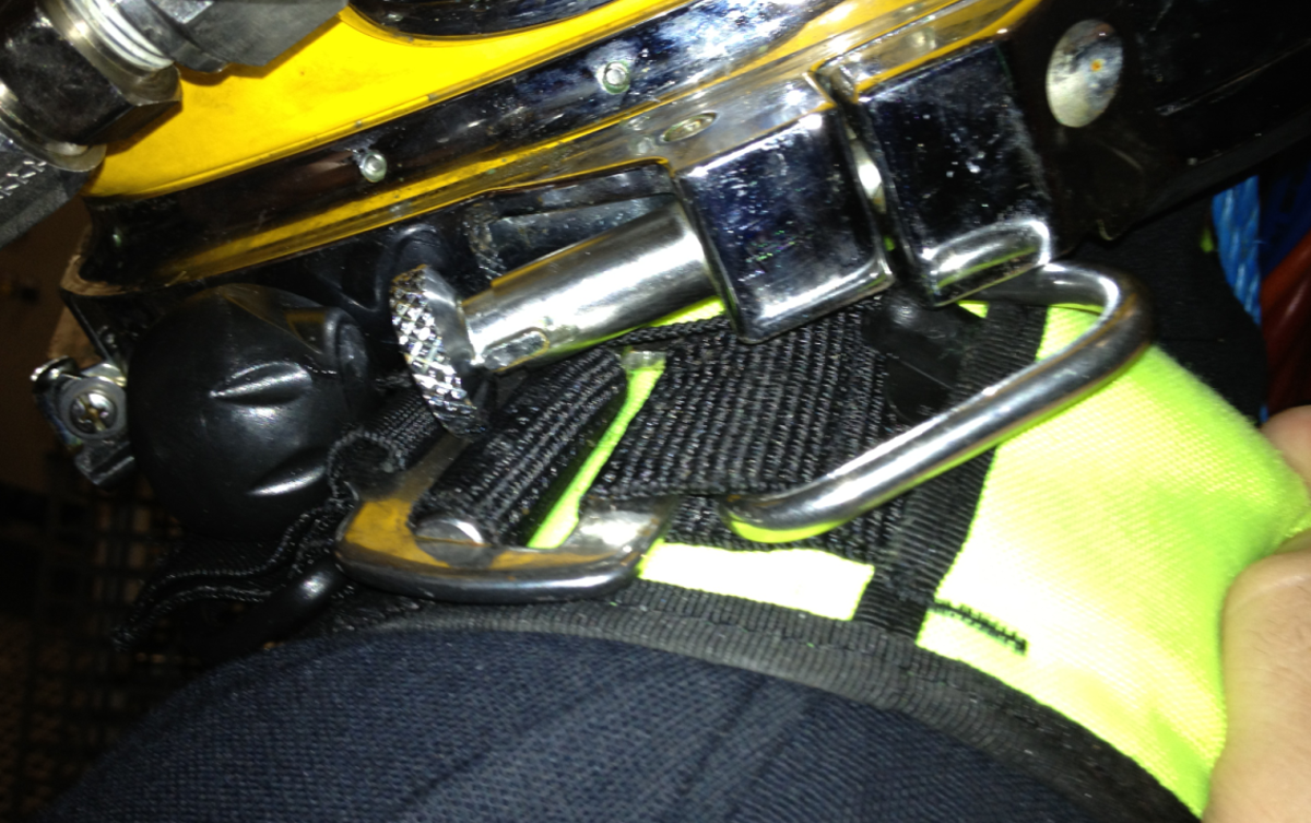 Clash between diver helmet pull pin and jump jacket