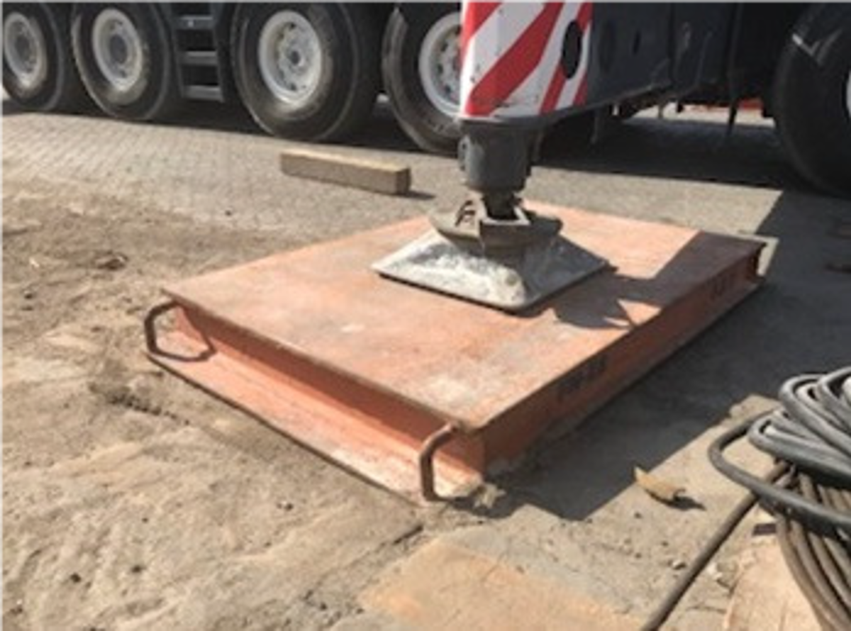The employee who was in the process of retrieving the timber block from underneath the suspended pad sustained hand injuries when the pad fell.