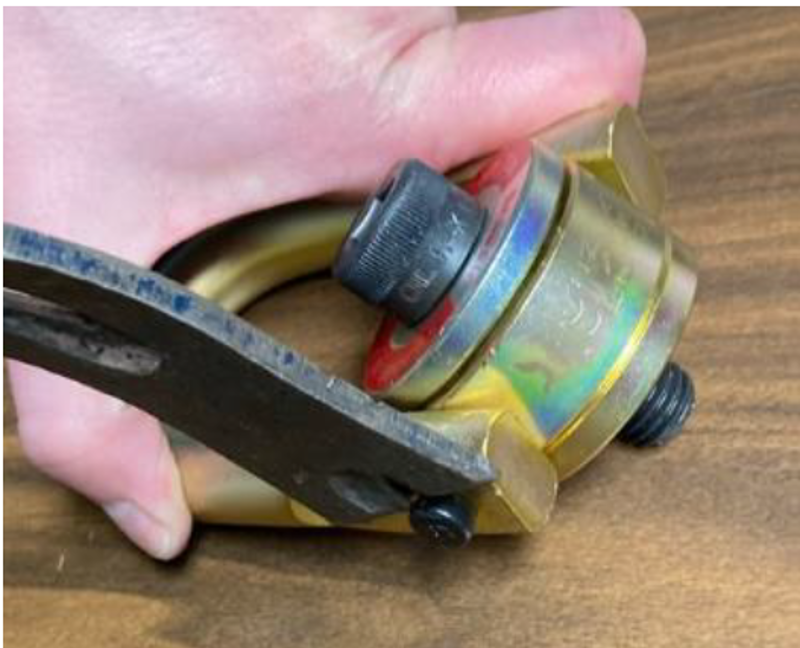 The inspection can be accomplished by taking a small flat rigid object (such  as a thin pry bar) that can be inserted under the head of the hinge pin and  prying outwardly on the hinge pin.