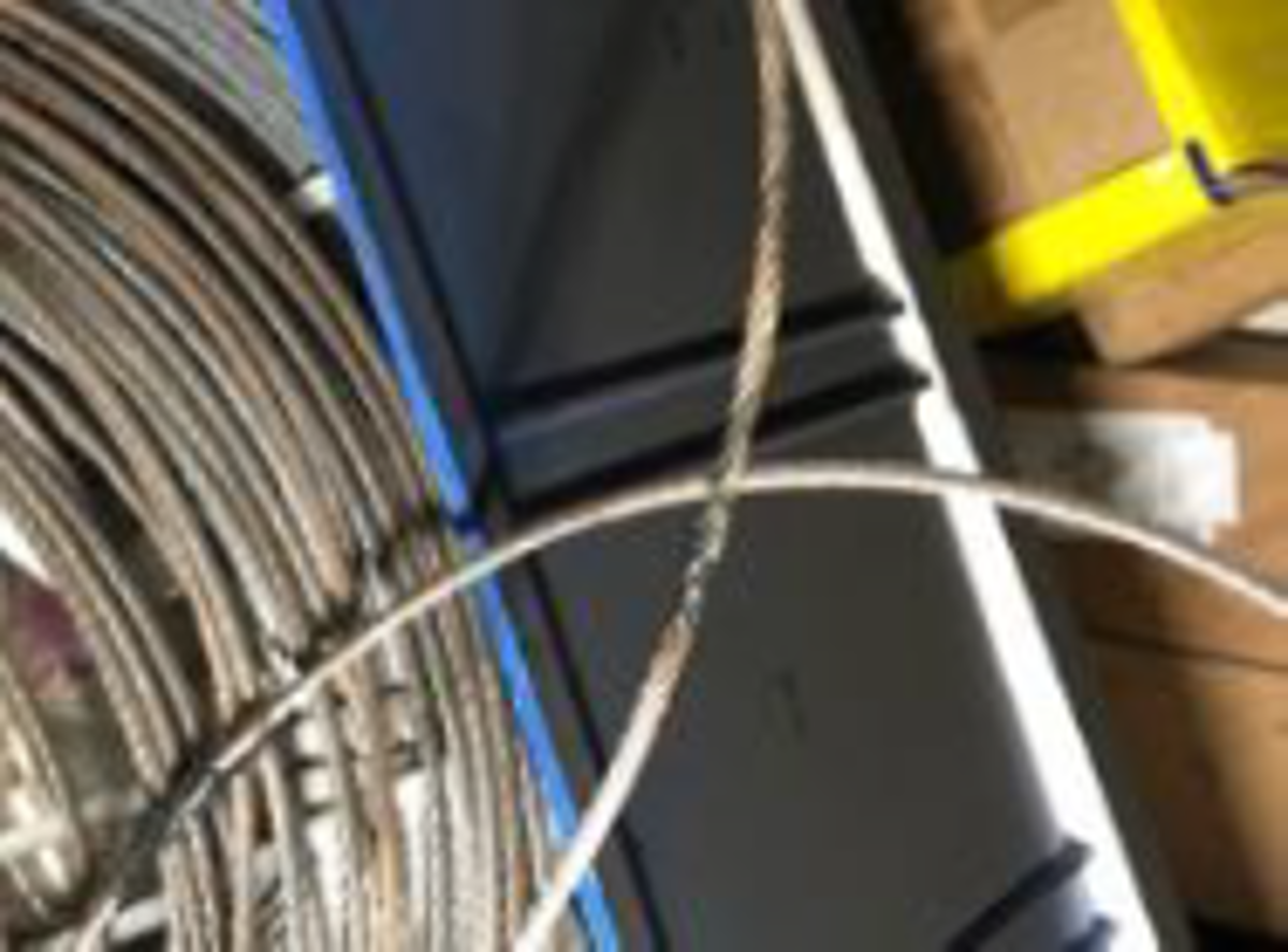 During rolling of the vessel, the steel wire fell from its position and came in contact with the spare Aldis battery.  This created a short circuit and caused high temperature/sparks