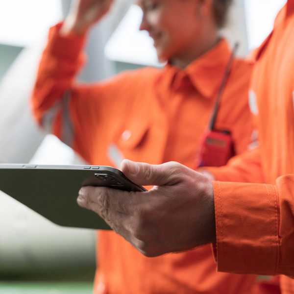 Stock image - Workers in overalls on ipad