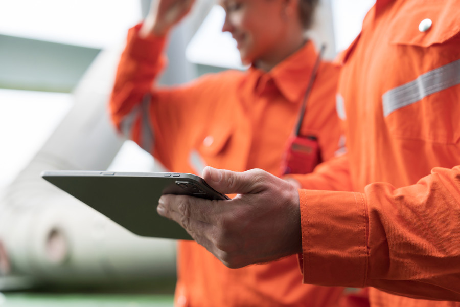 Stock image - Workers in overalls on ipad