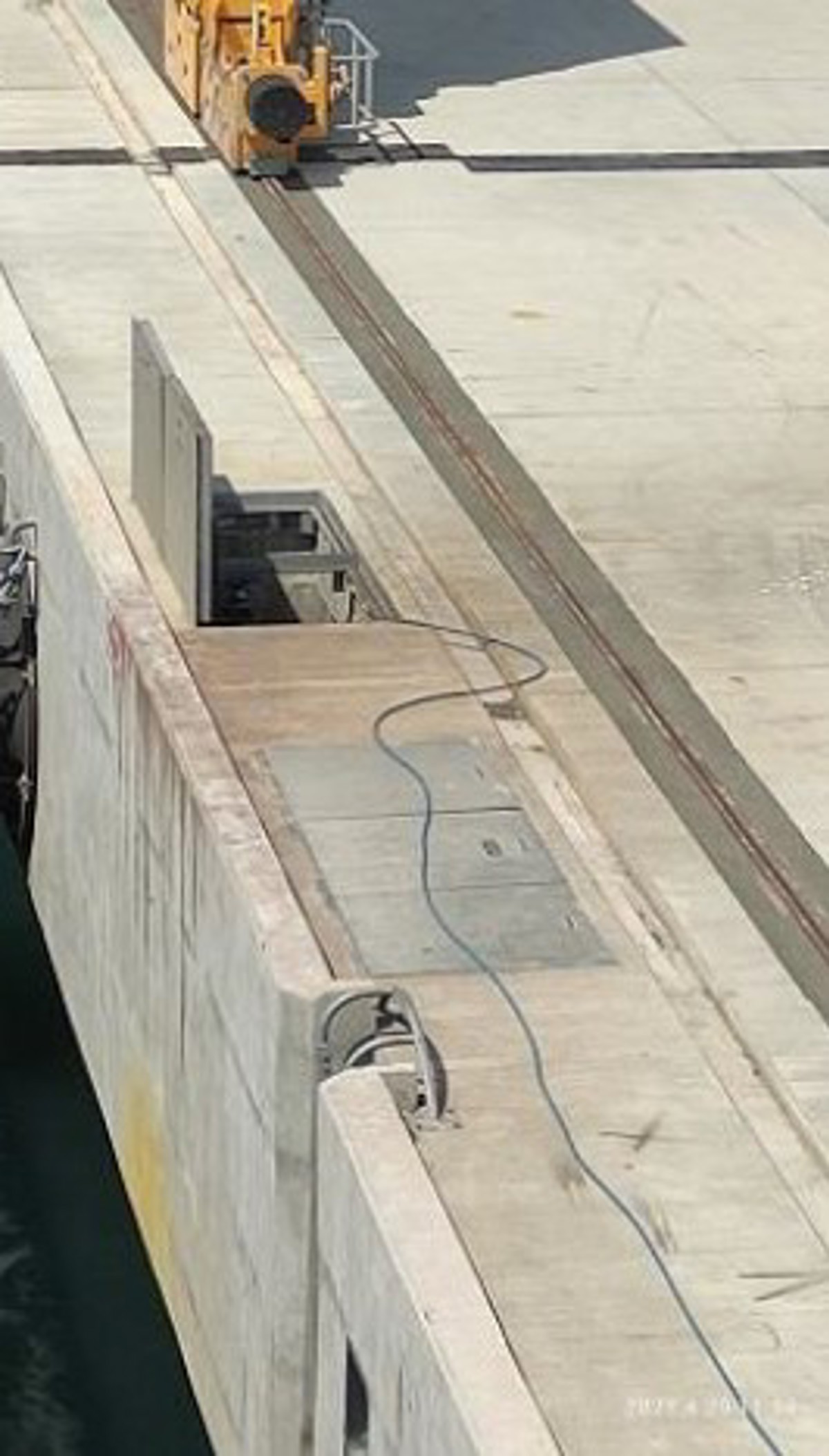 Two open hatches on the wharf near vessel, but no barricades or safety signs were installed