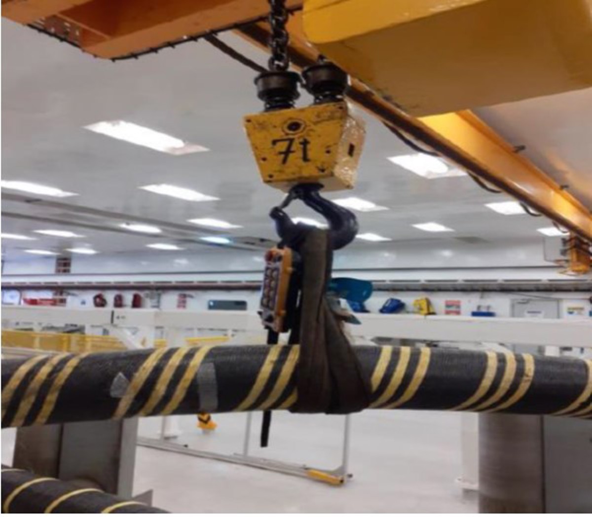 Hand pinched between cable and cable roller frame