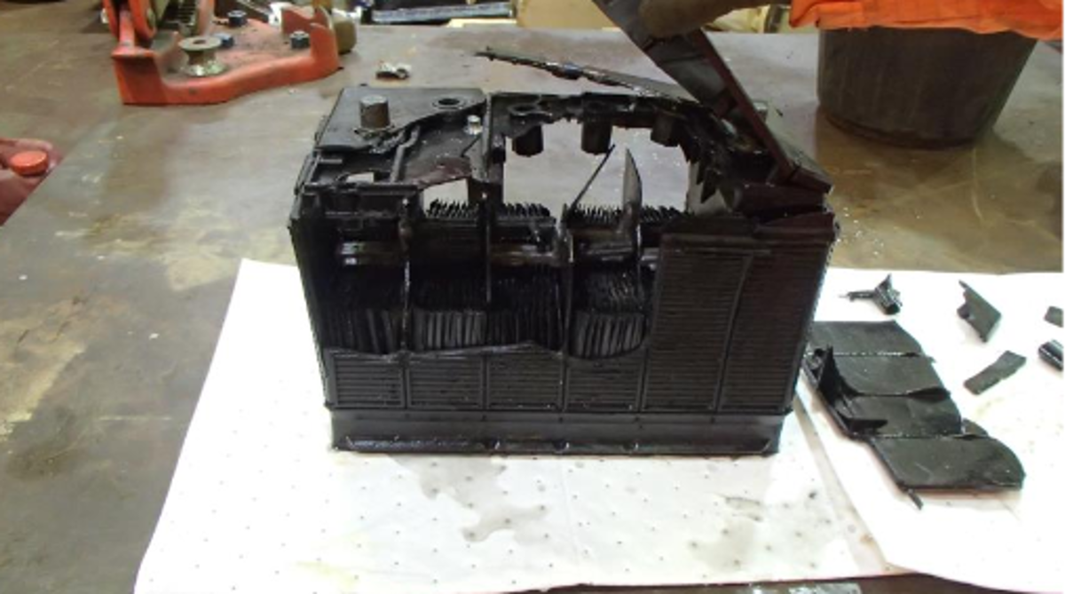 Pieces of the battery and fluid were expelled from the compartment having been partially restricted by the closed hatch lid